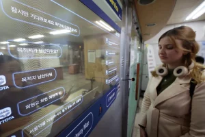 Foreign tourists using AI translation services at Hongik University Station in Seoul