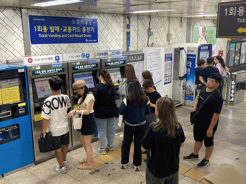 Foreign tourists queuing to buy subway tickets at Myeongdong Station in Seoul